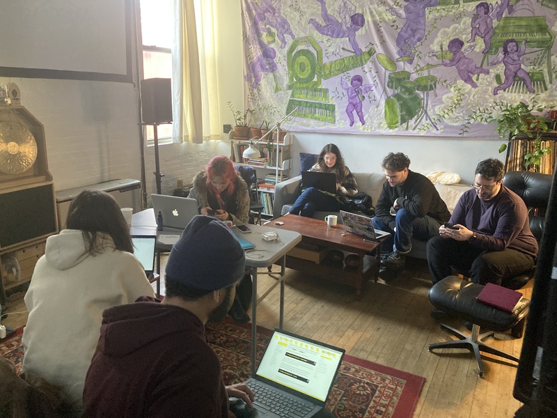 Folks working on their computer on couches and chairs