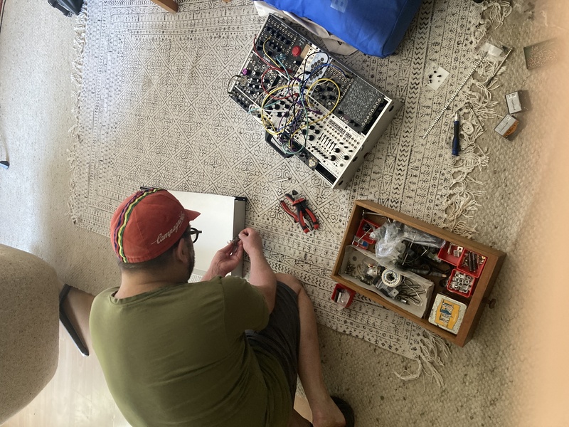 Janek leaning over fixing the eurorack case Janek leaning over my synth