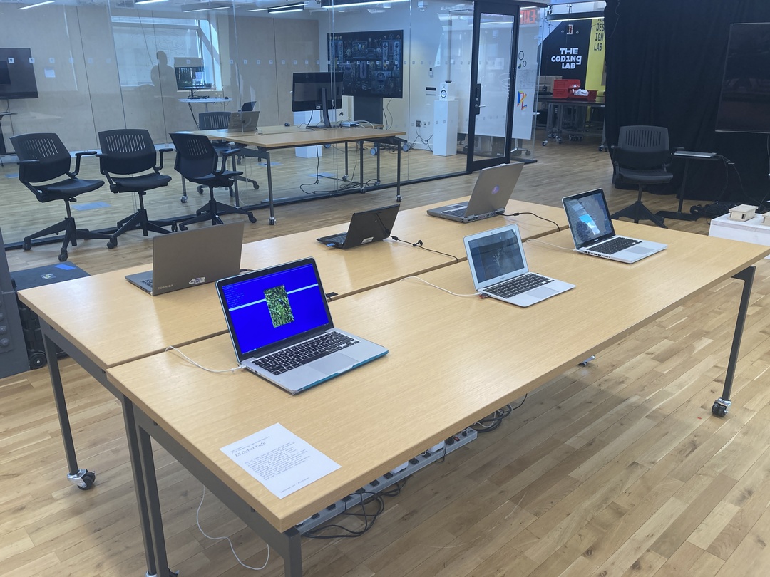 a table spread with 6 older laptops showing code-based artworks