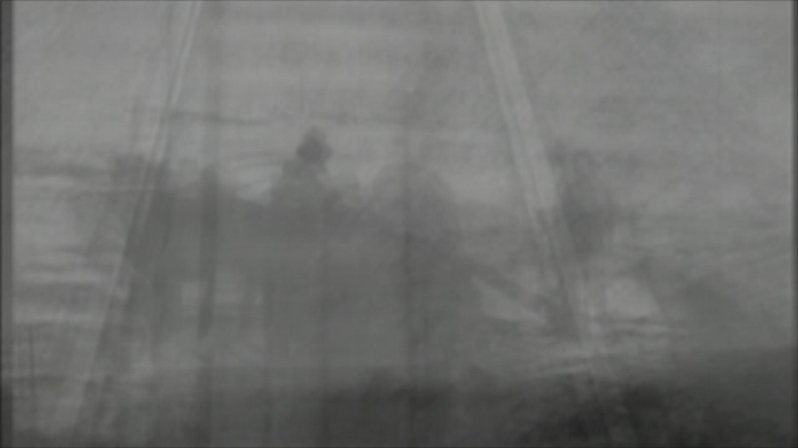 Screenshot of Distances black and white video with people silhouettes on top of railroad tracks