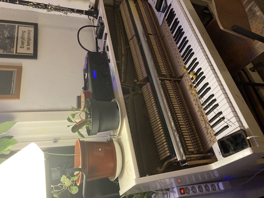 a broken open piano with mic