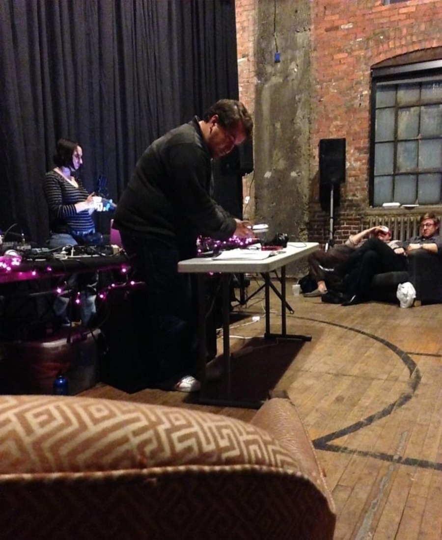 Tim Bieniosek setting up audio devices on a table.